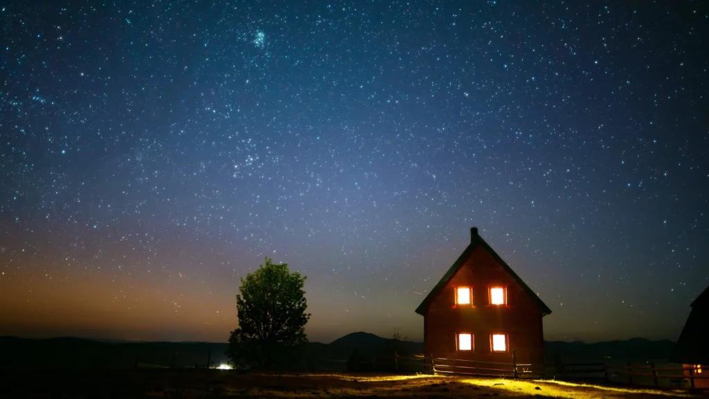 Meadow and a wooden cottage under the starry night, Durmitor (Montenegro)